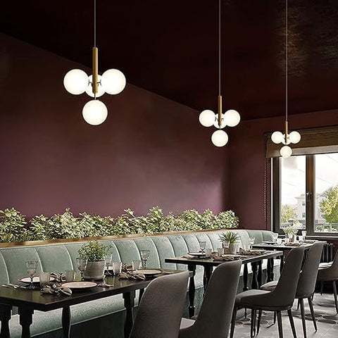 Modern restaurant interior with tables, chairs, and pendant lights.