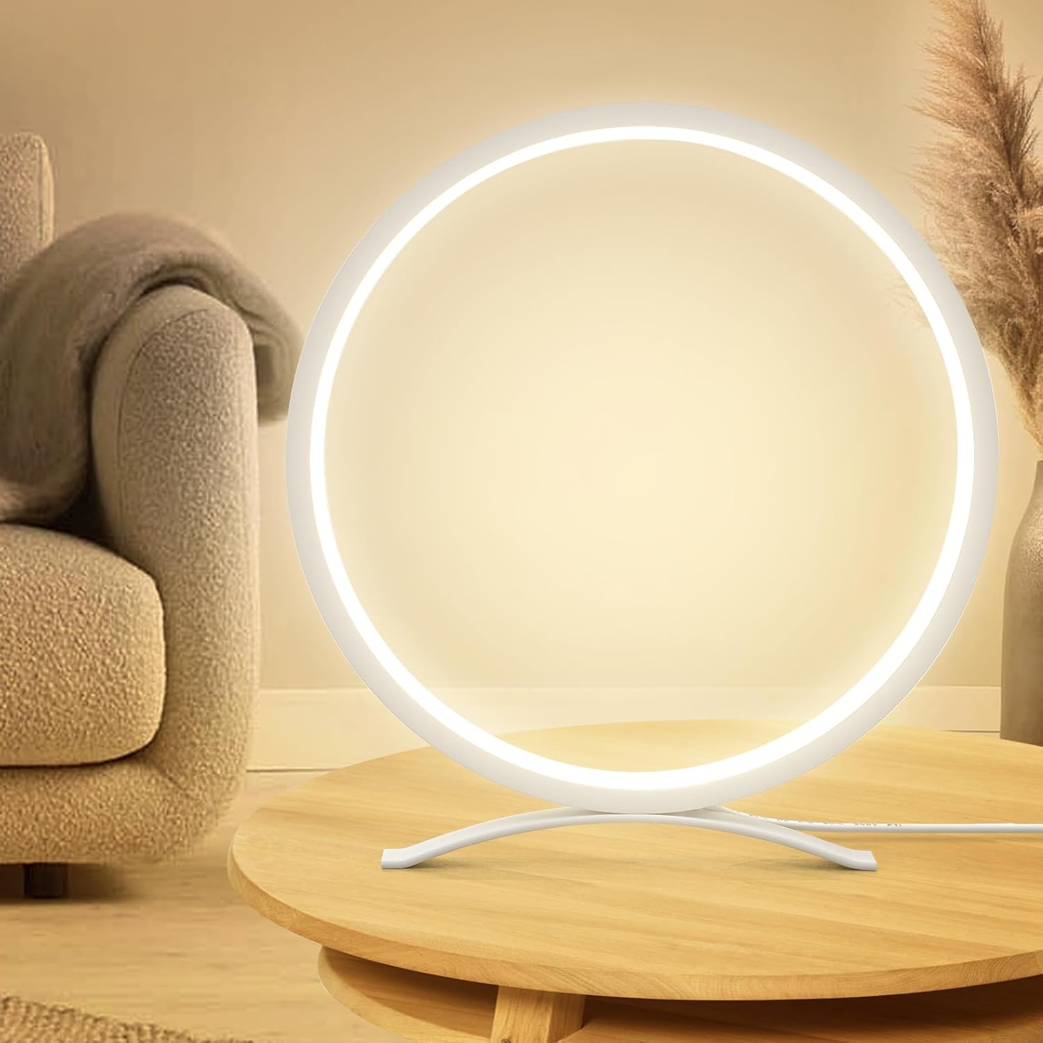 Modern round table lamp on a wooden surface with a beige sofa and decorative plant in the background.
