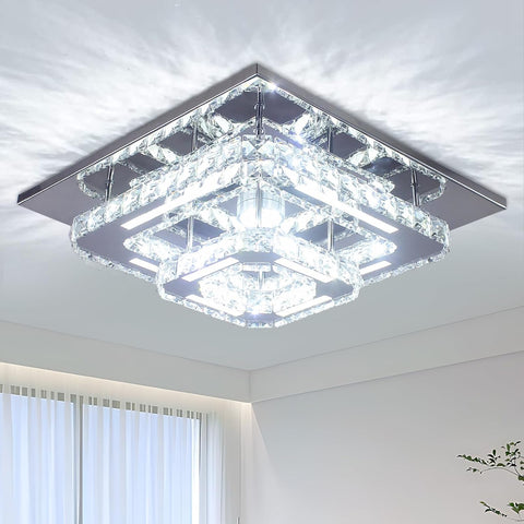 Modern square ceiling light fixture in a room with white walls and a window.