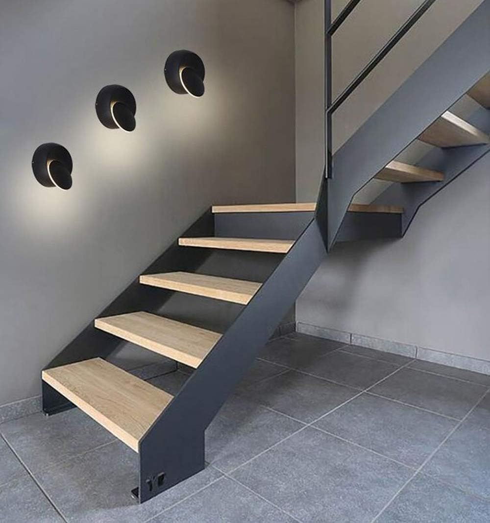 Modern staircase with wooden steps and metal railings in a gray room.