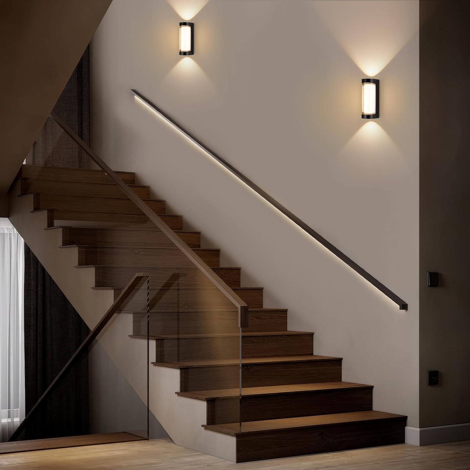Modern staircase with wooden steps and wall lights in a home interior.