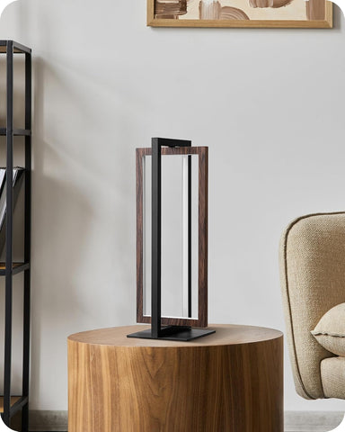 Modern table lamp on a wooden side table with a neutral background