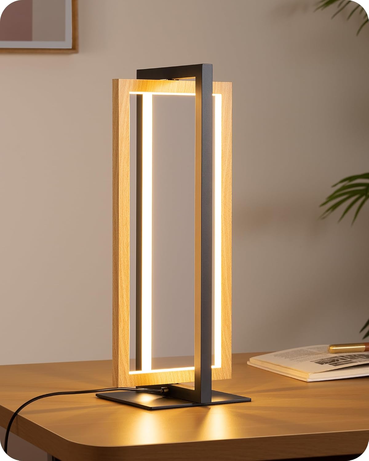 Modern table lamp with wooden frame and black base on a wooden surface.