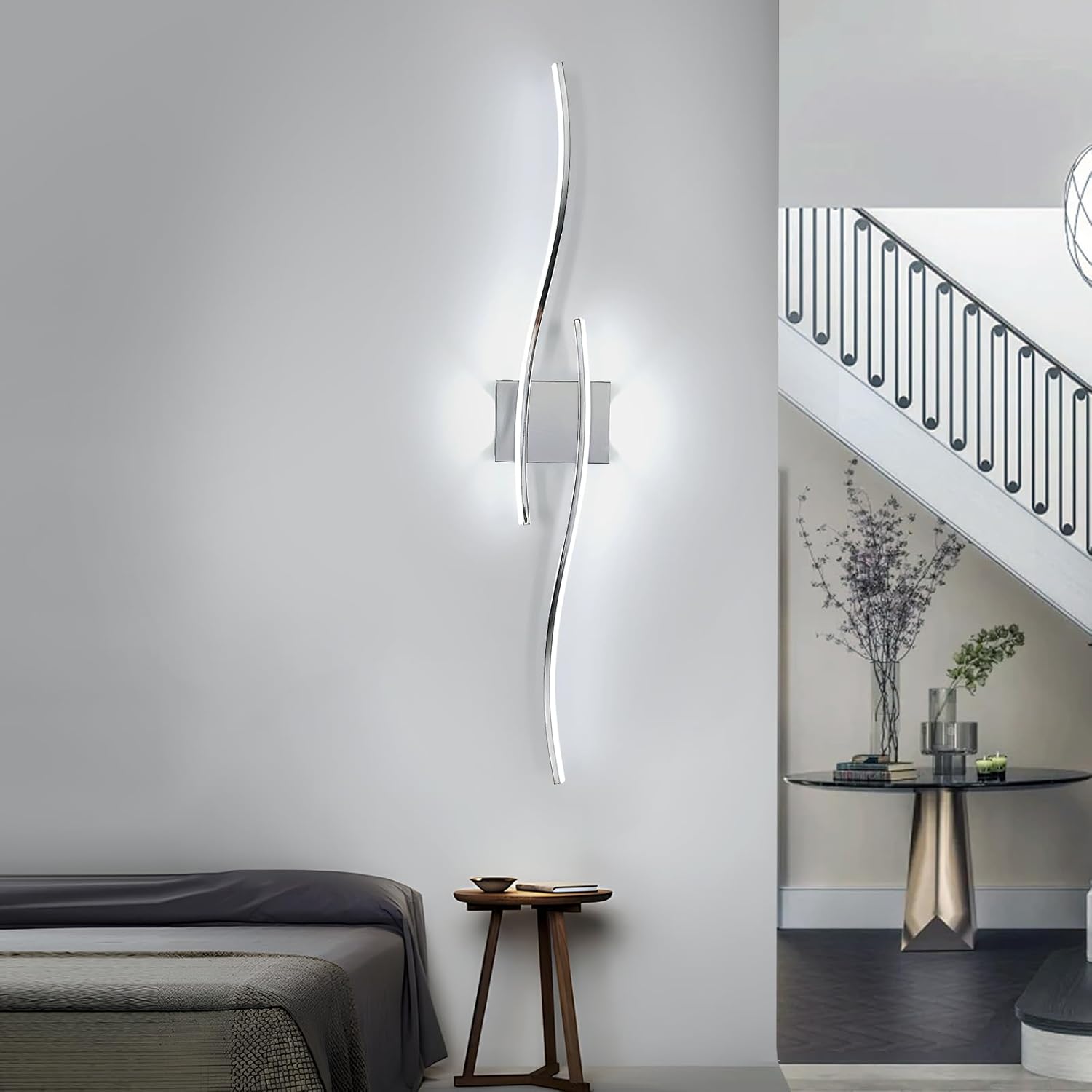 Modern wall-mounted light fixture in a bedroom setting with a bed and side table.