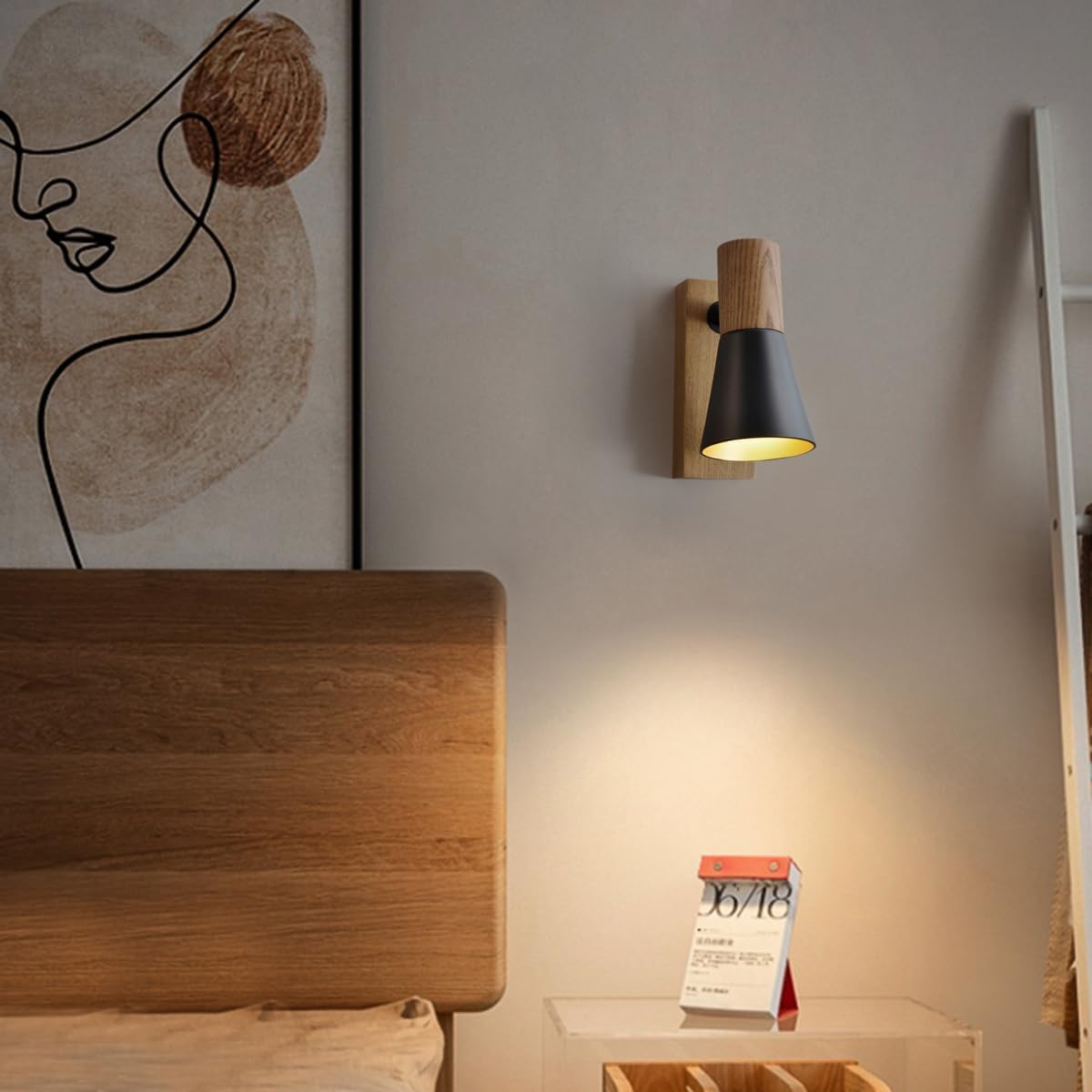 Modern wall lamp above a wooden headboard with a minimalistic abstract art piece on the wall.