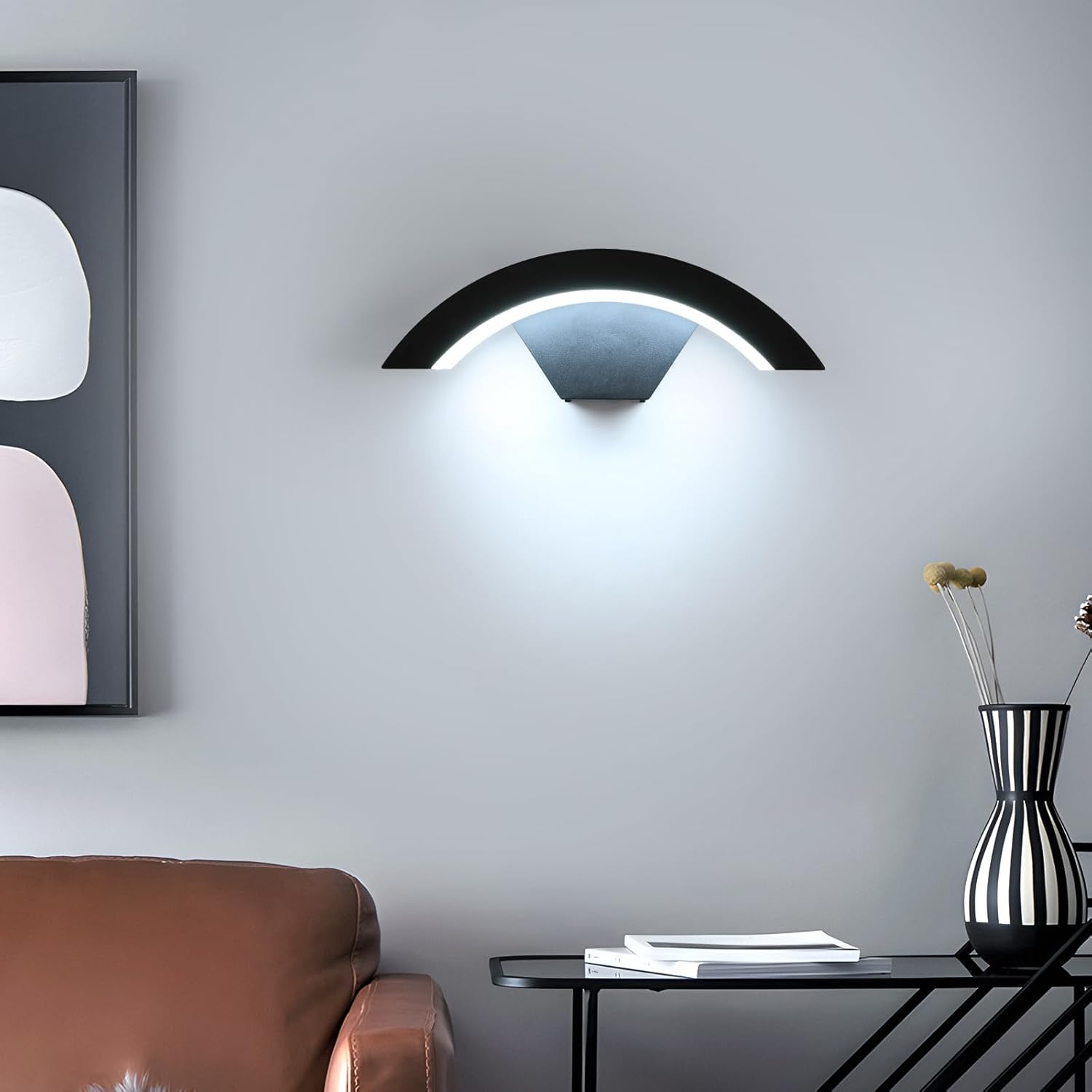 Modern wall lamp in a living room setting with a sofa and decorative items.