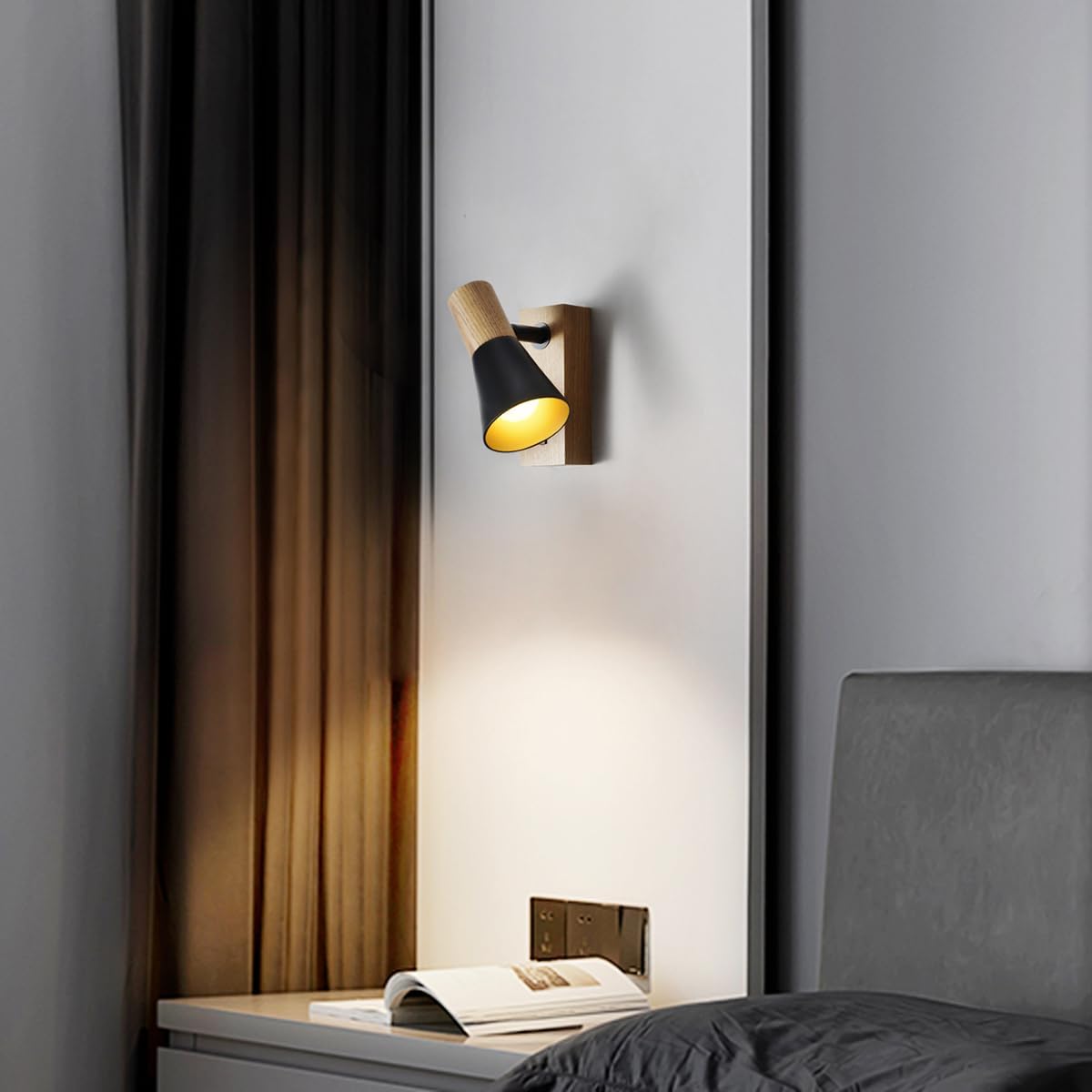 Modern wall lamp on a gray wall with a bed and curtains in the background