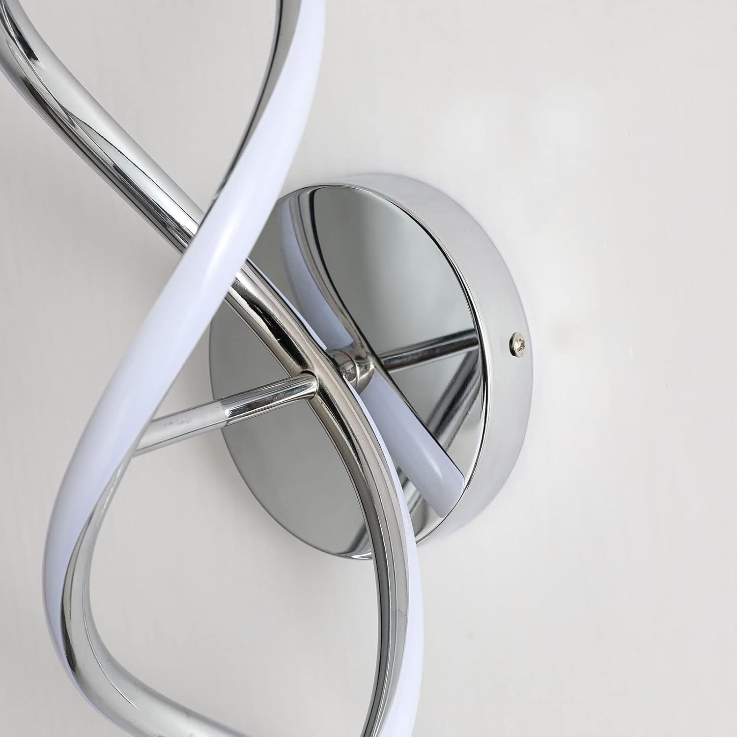 Modern wall light fixture with chrome finish and white accents on a neutral background