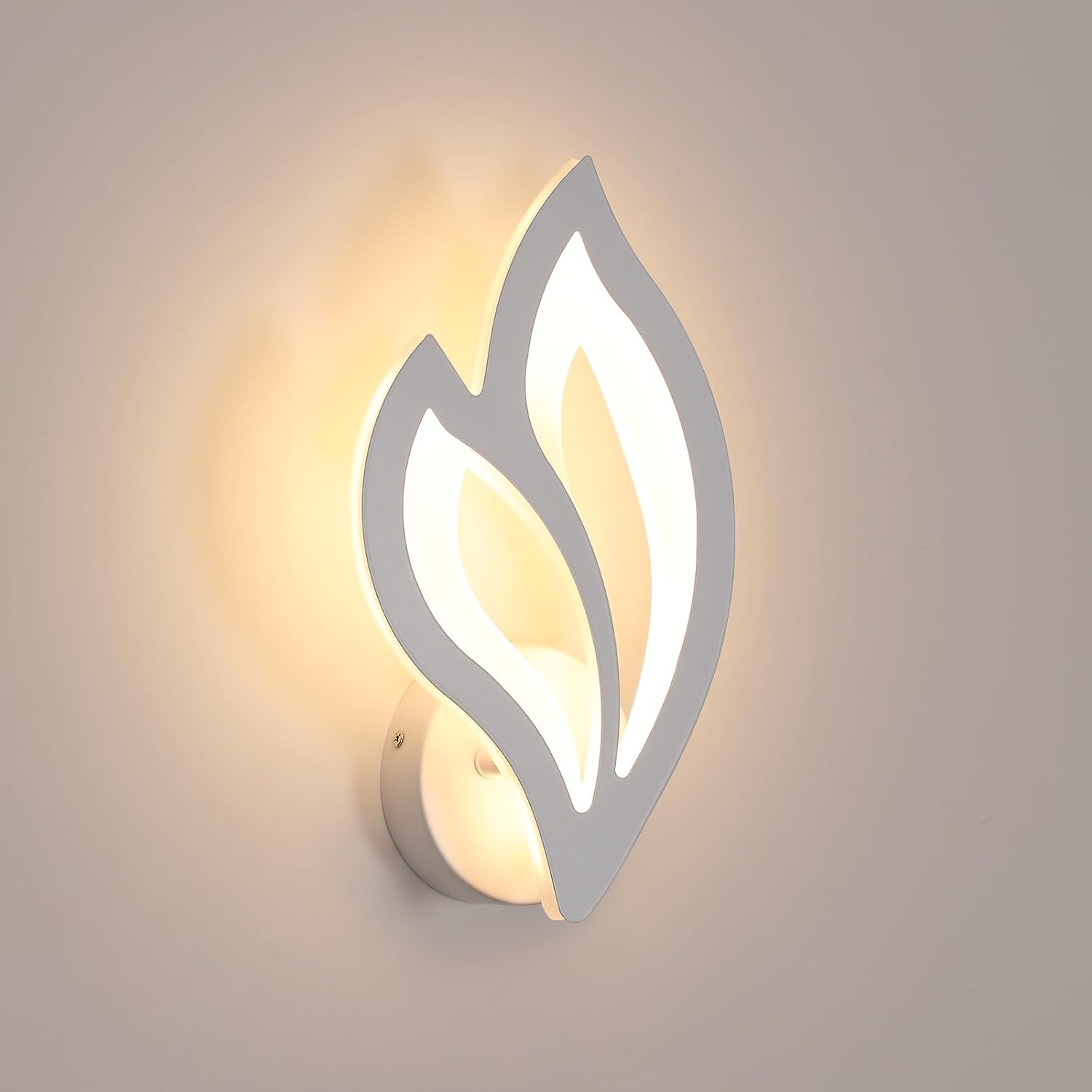 Modern wall light fixture with leaf-like design on a neutral background