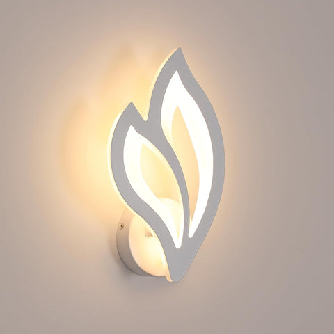 Modern wall light fixture with leaf-like design on a neutral background