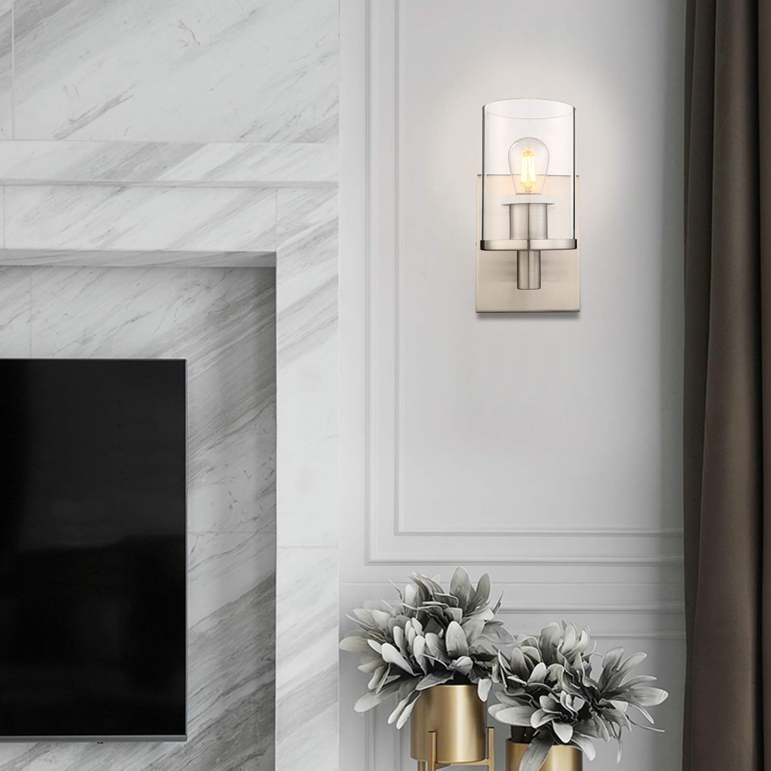 Modern wall sconce mounted on a white wall above a fireplace.

