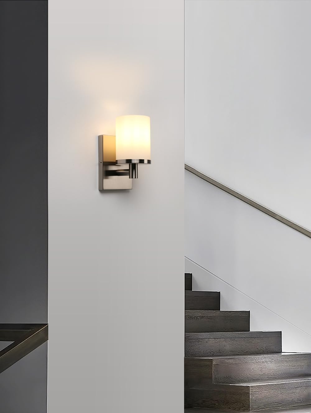 Modern wall sconce on a white wall with a staircase in the background