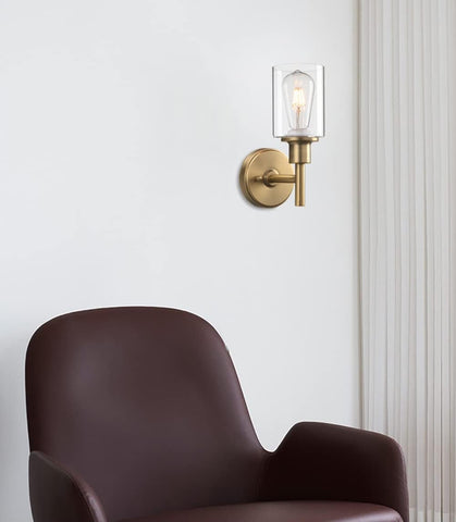 Modern wall sconce with a brown chair against a white wall
