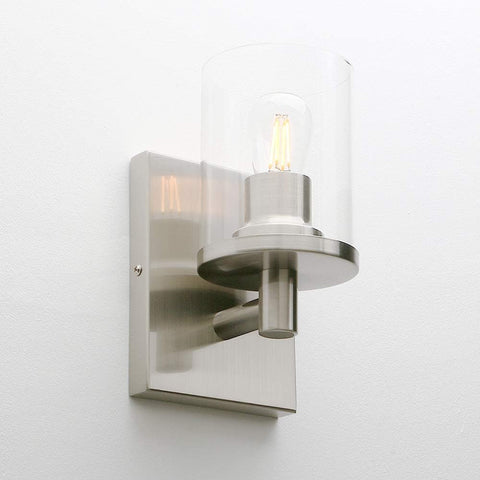 Modern wall sconce with glass shade on a white background