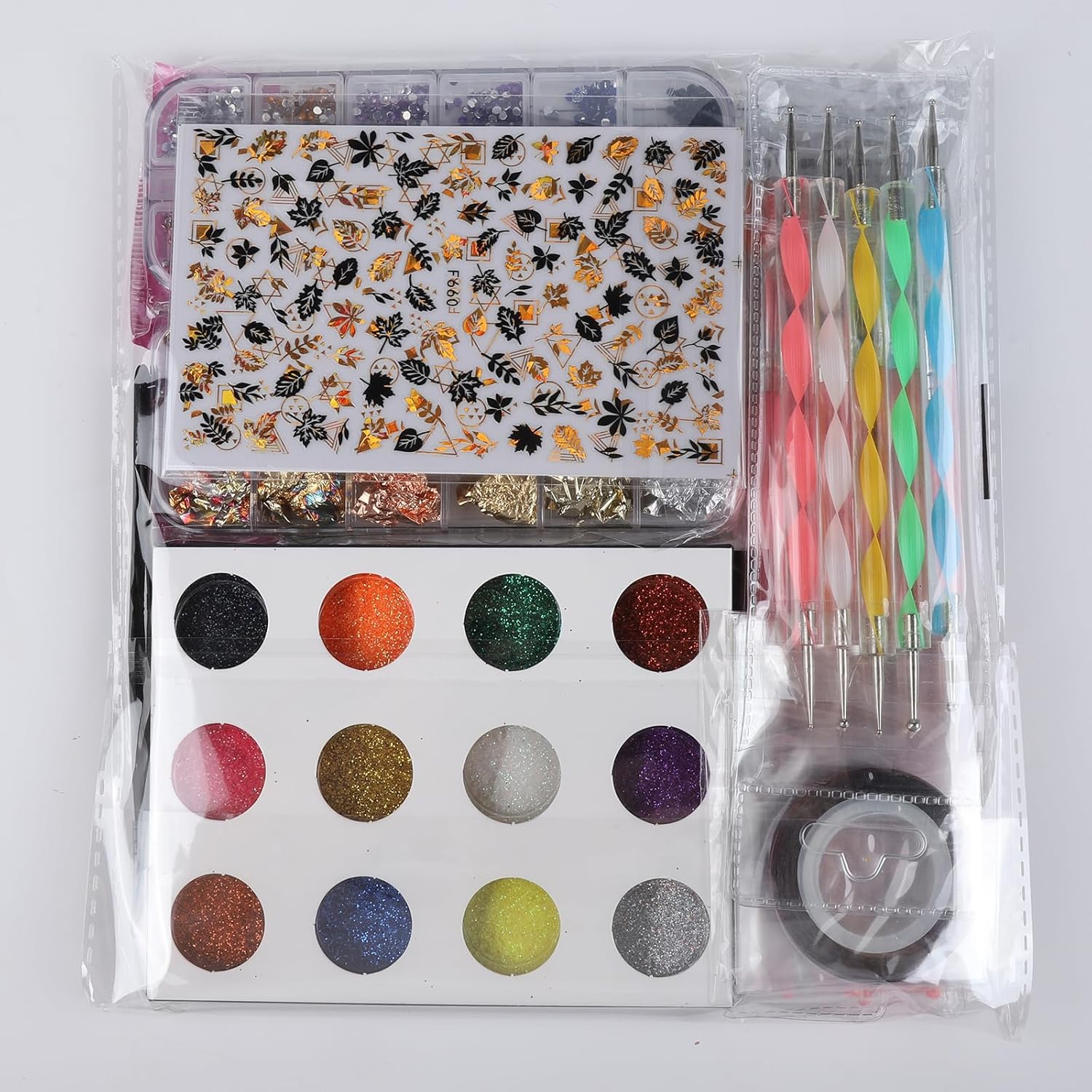 Nail art set with stickers, glitter, and tools on a white background