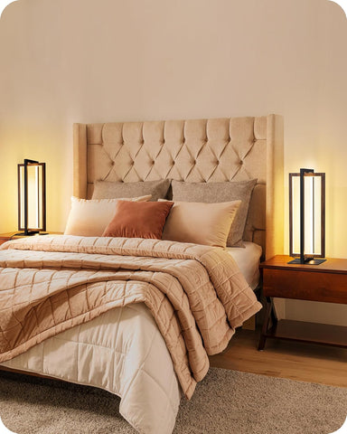 Neatly made bed with beige and brown bedding in a bedroom setting.