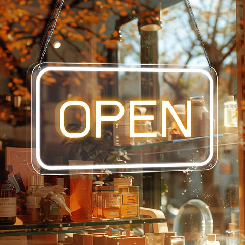 Neon 'OPEN' sign in a store window with autumn foliage outside