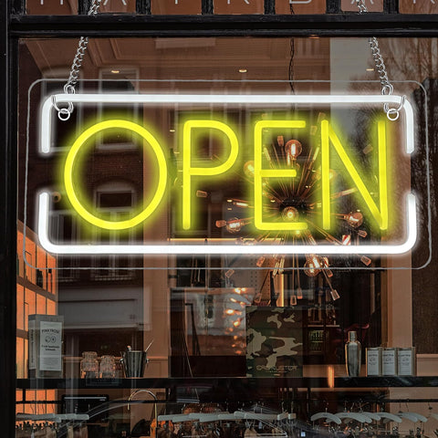 Neon 'OPEN' sign in a store window with interior reflections.