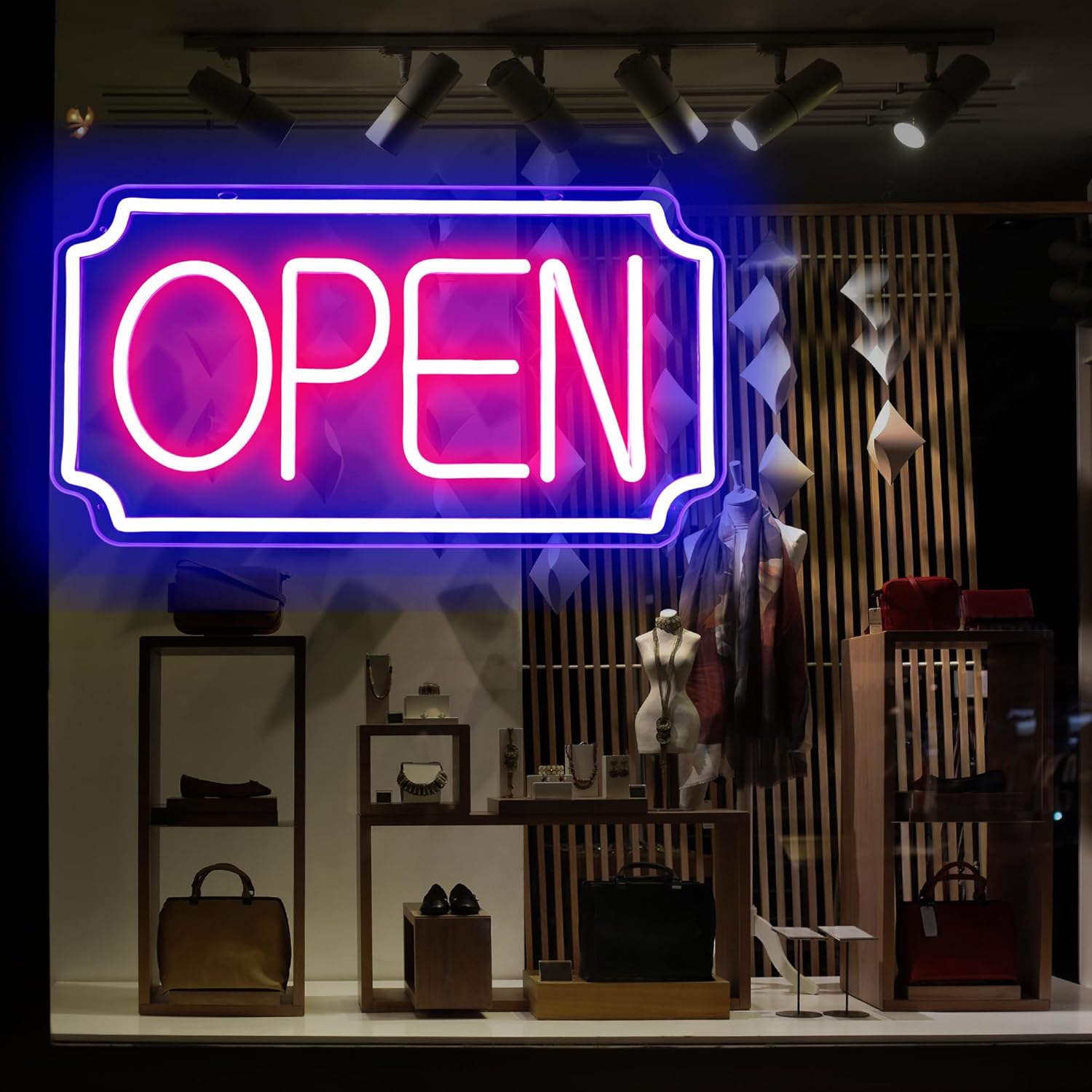 Neon 'OPEN' sign in a store window with various items on display.