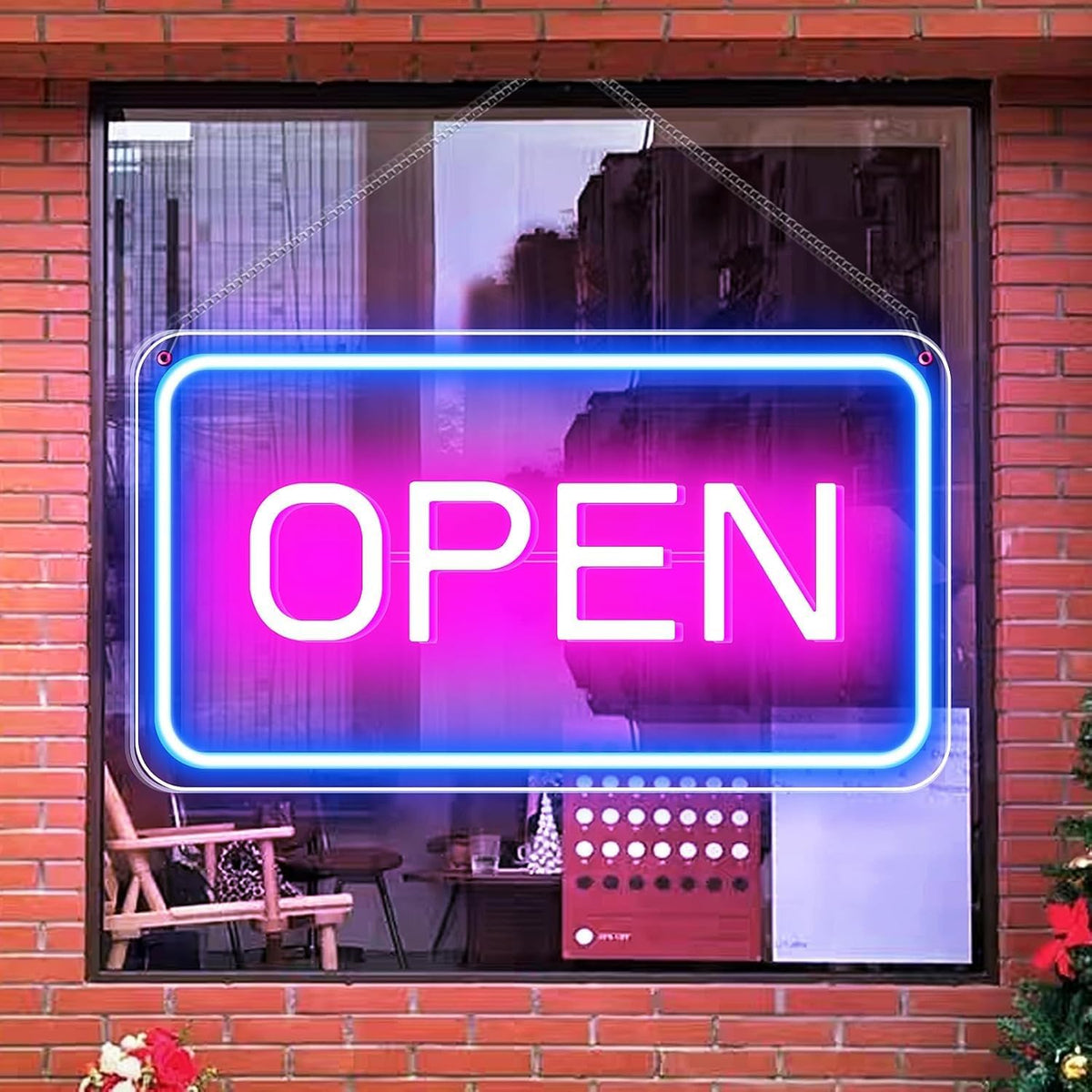 Neon 'OPEN' sign on a window with a brick wall background