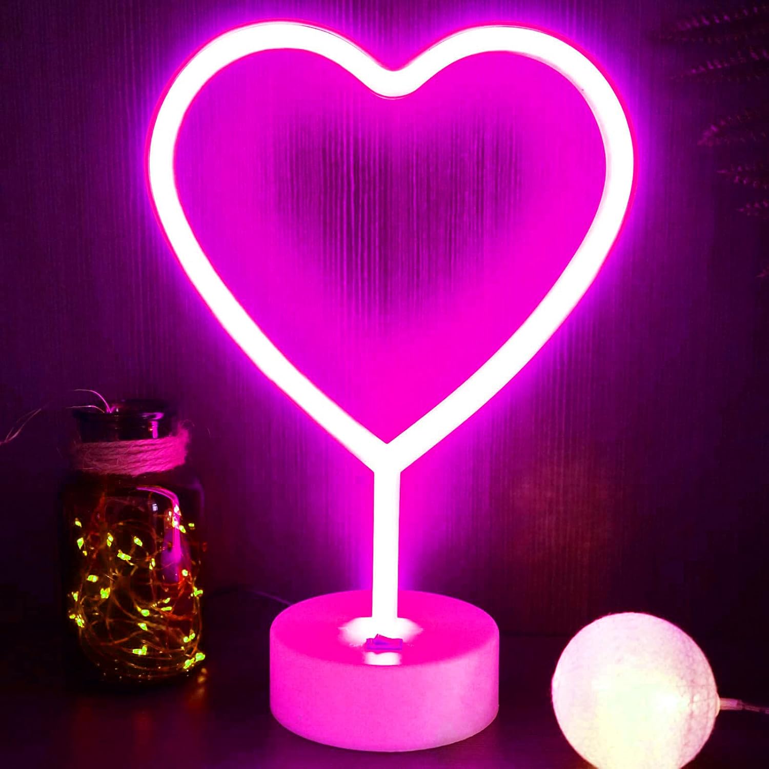 Neon heart-shaped light on a purple background