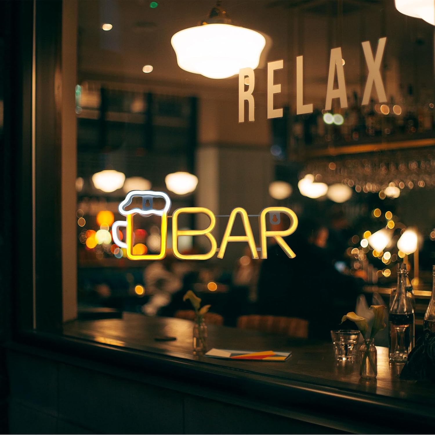 Neon sign inside a bar with 'U Bar' and 'Relax' text.