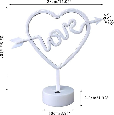 Neon sign shaped like a heart with the word 'love' inside, on a stand against a pink background.