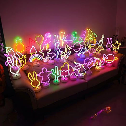 Neon sign shaped like a heart with the word 'love' inside, on a stand against a pink background.