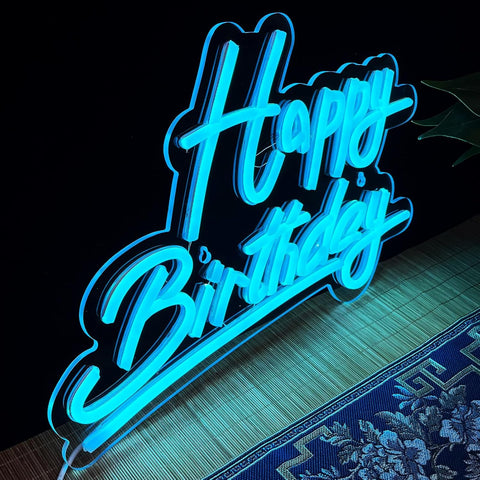 Neon sign with 'Happy Birthday' text on a dark background