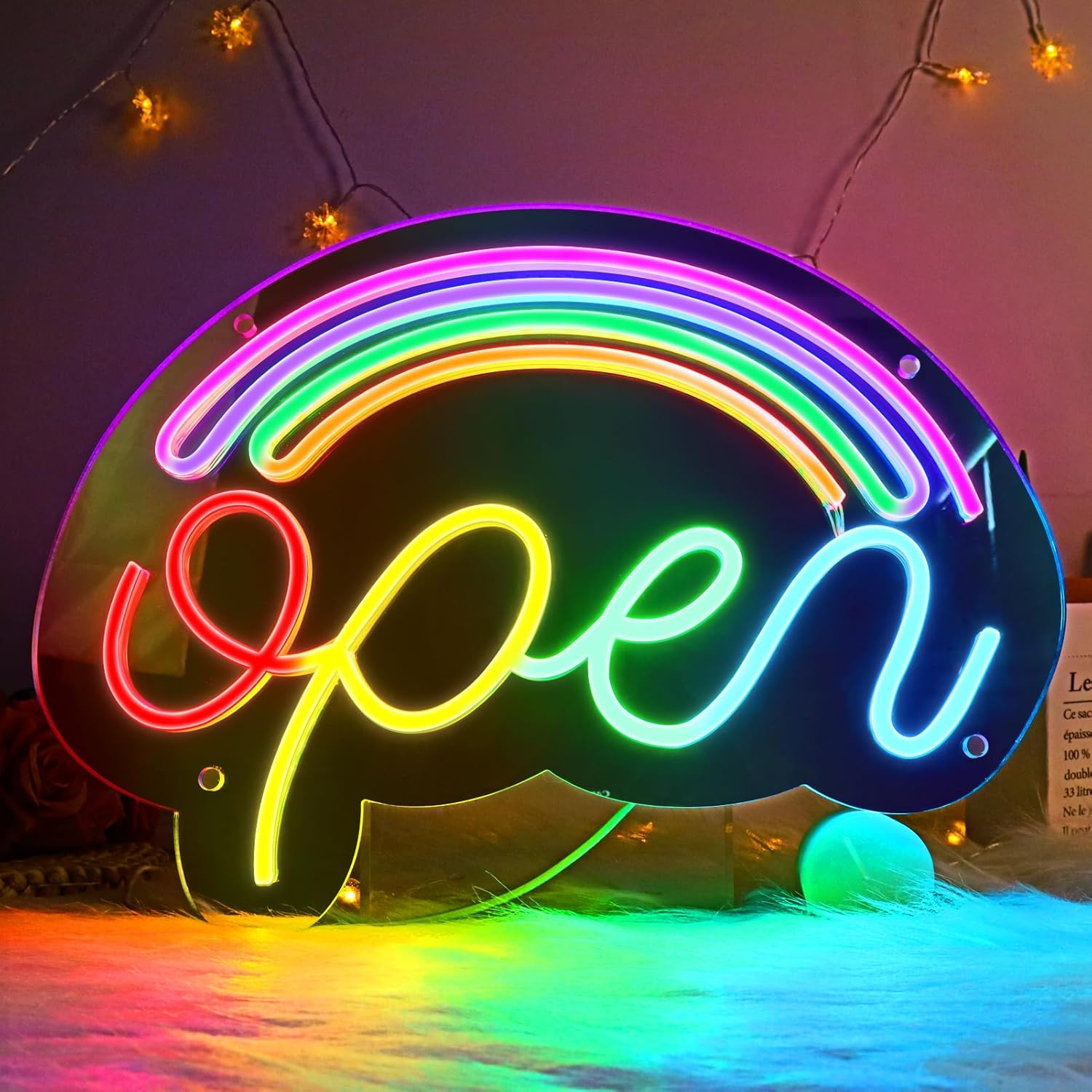Neon sign with rainbow colors and 'open' text, surrounded by string lights.