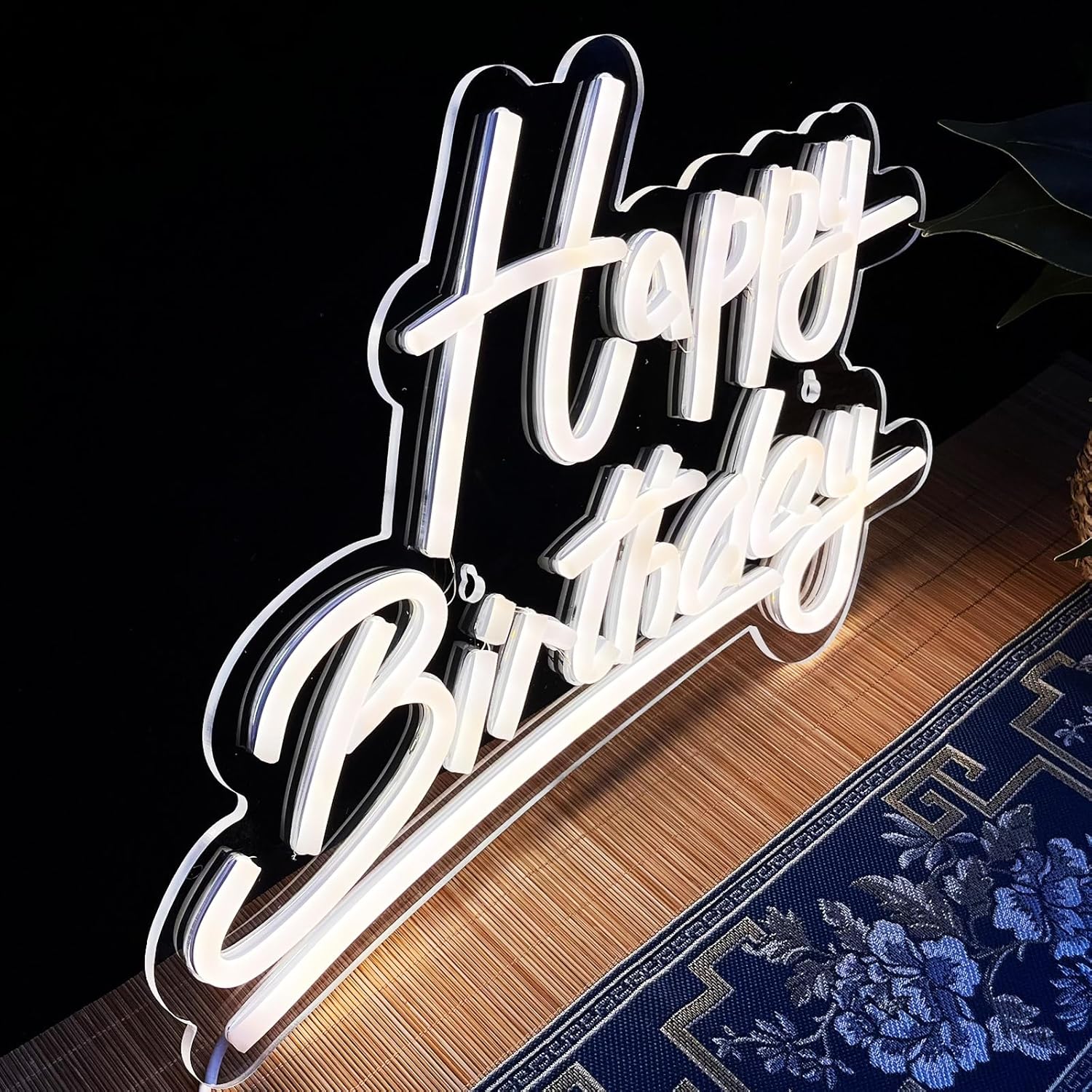 Neon sign with 'Happy Birthday' text on a dark background