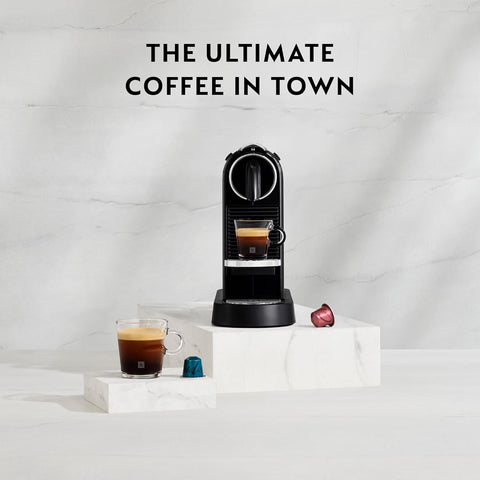 Nespresso coffee machine with a cup of coffee on a white marble surface