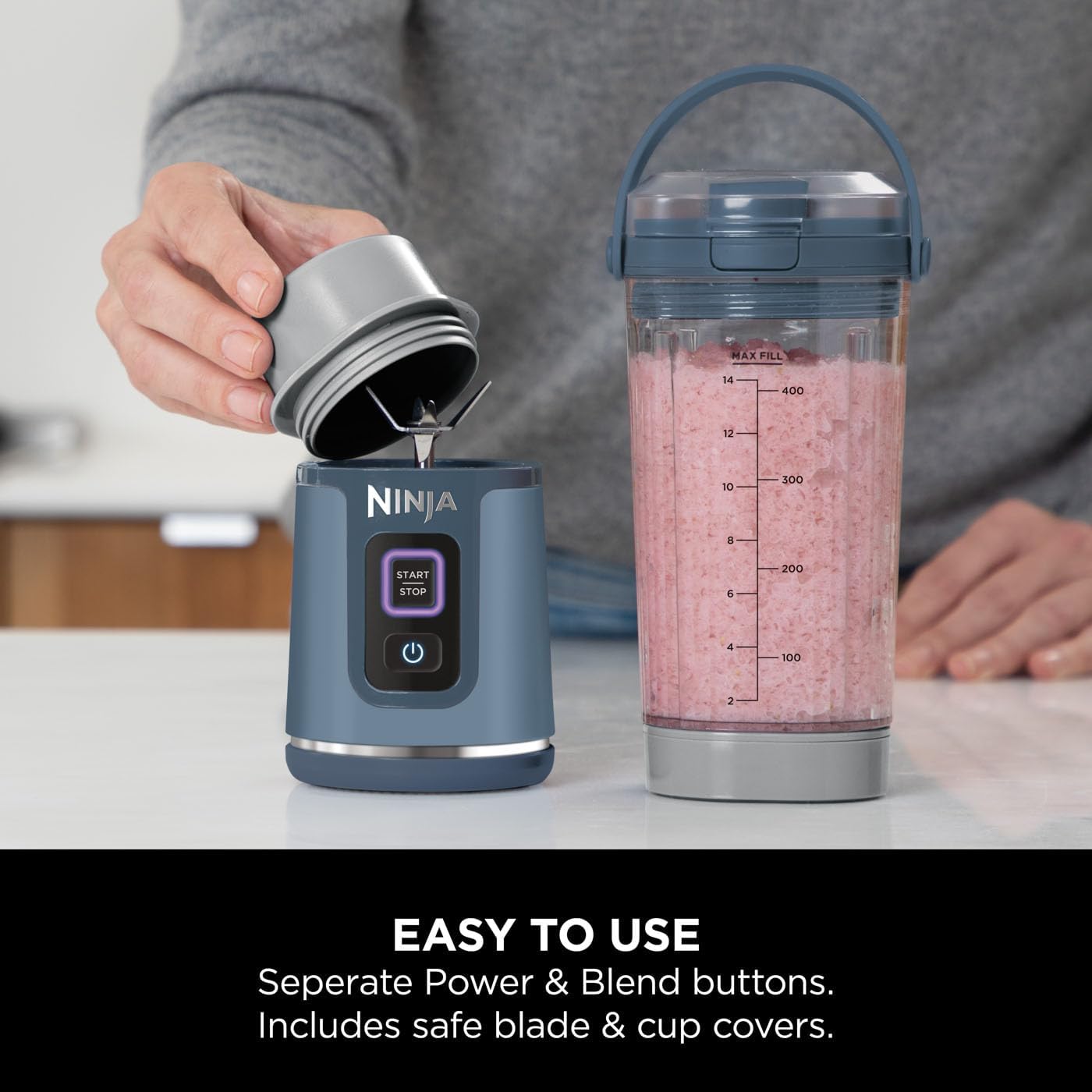 Ninja blender with pink smoothie on a kitchen counter