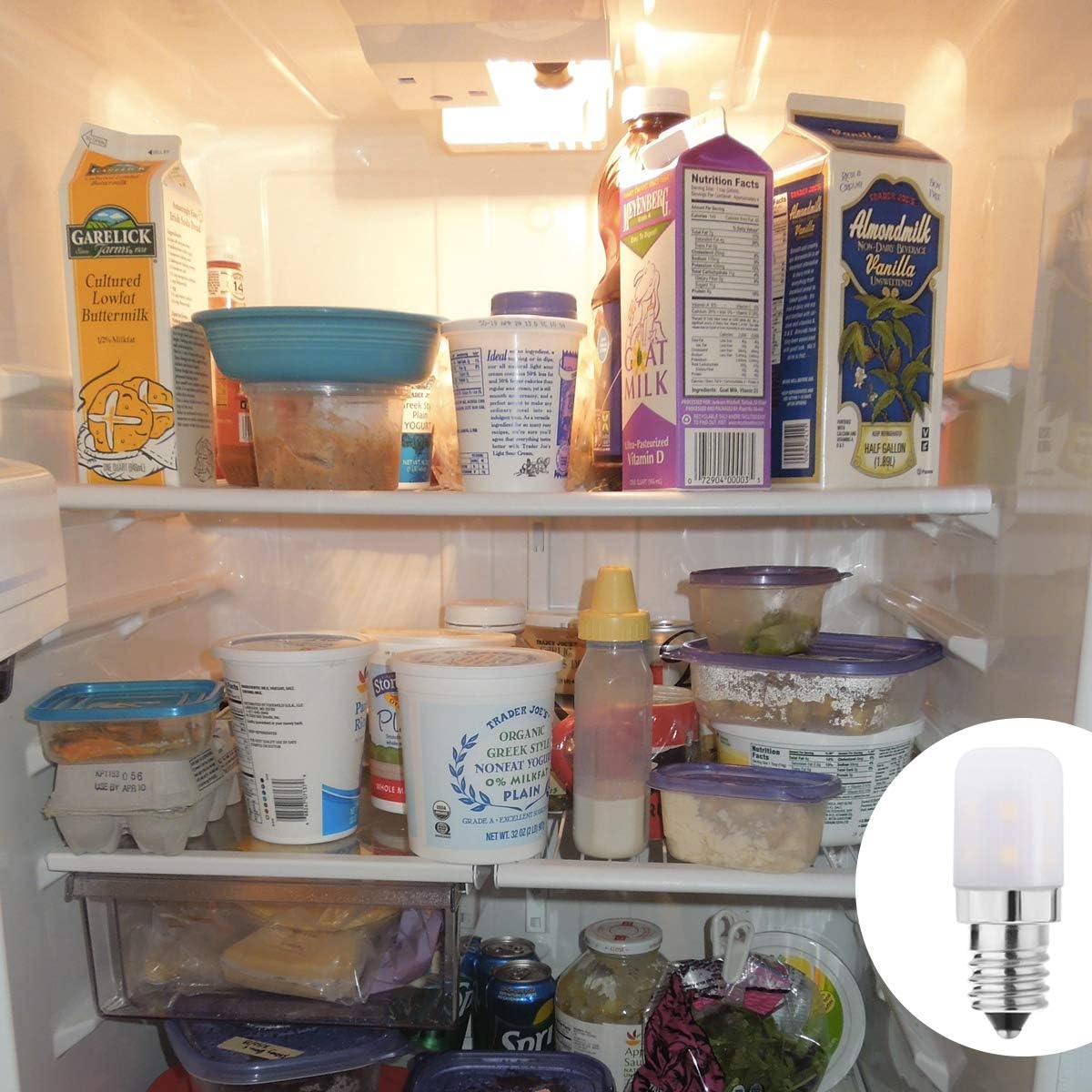 Open refrigerator with various food items and a light bulb inset