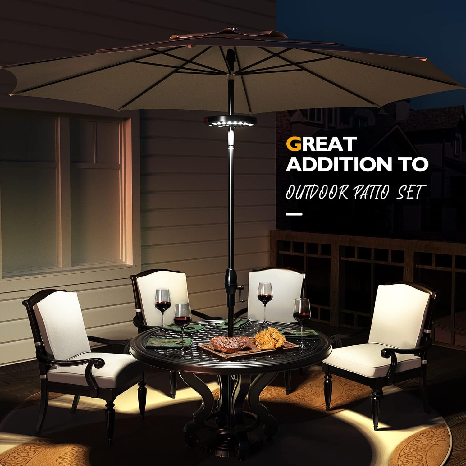 Outdoor patio set with table, chairs, and umbrella at night.
