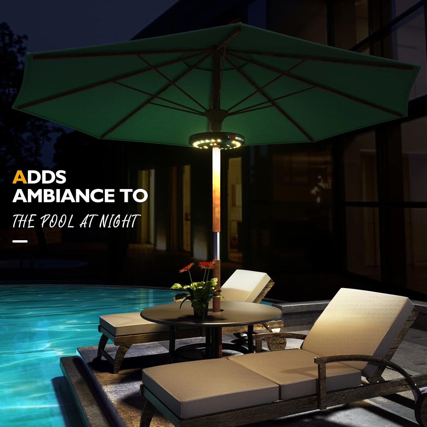 Outdoor patio setting with a green umbrella and lounge chairs by a pool at night.