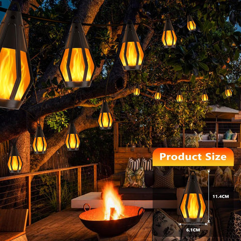 Outdoor setting with hanging lantern-like lights and a fire pit.