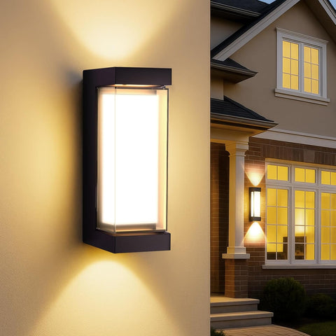 Outdoor wall light fixture on a house exterior with warm glow