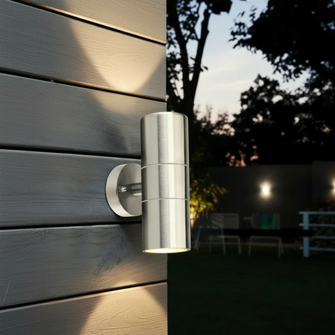 Outdoor wall light fixture on a wooden wall with a night scene showing its illumination.
