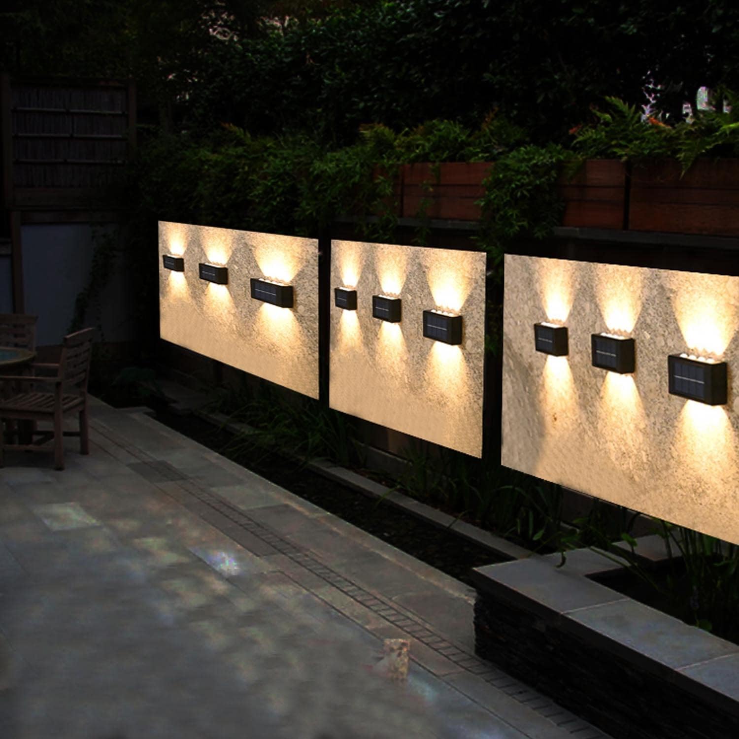 Outdoor wall lights illuminating a pathway at night