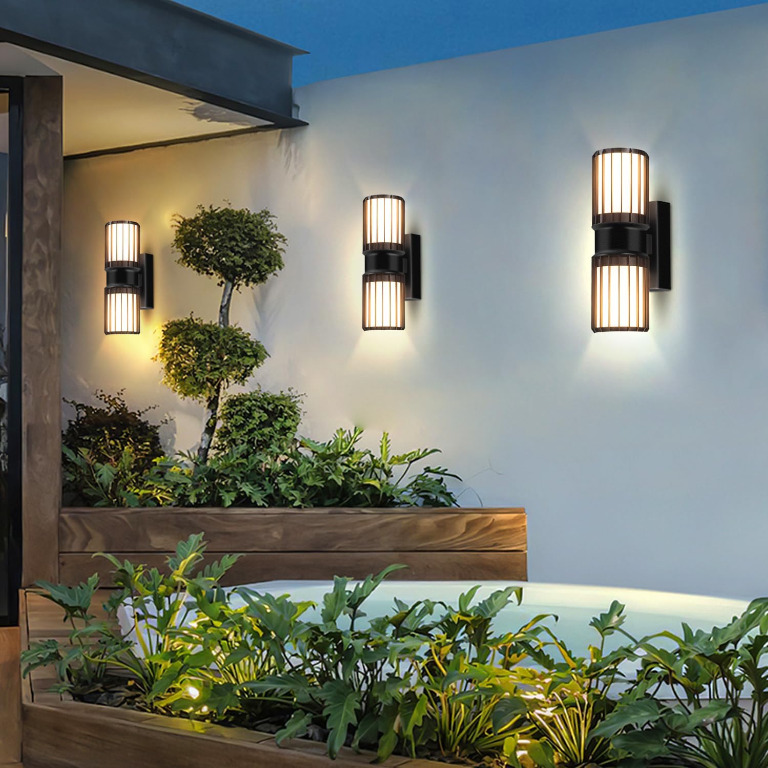 Outdoor wall lights on a building exterior with plants and a pool.