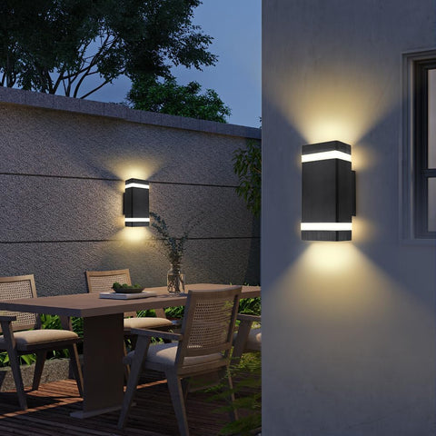 Outdoor wall lights on a building with a dining area in the background
