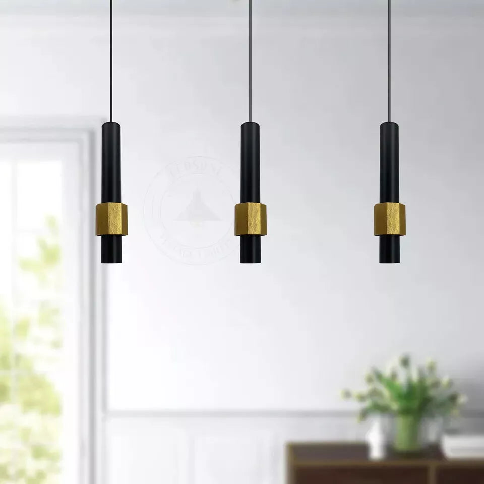 Black cylinder pendant light hanging over a modern kitchen island.

