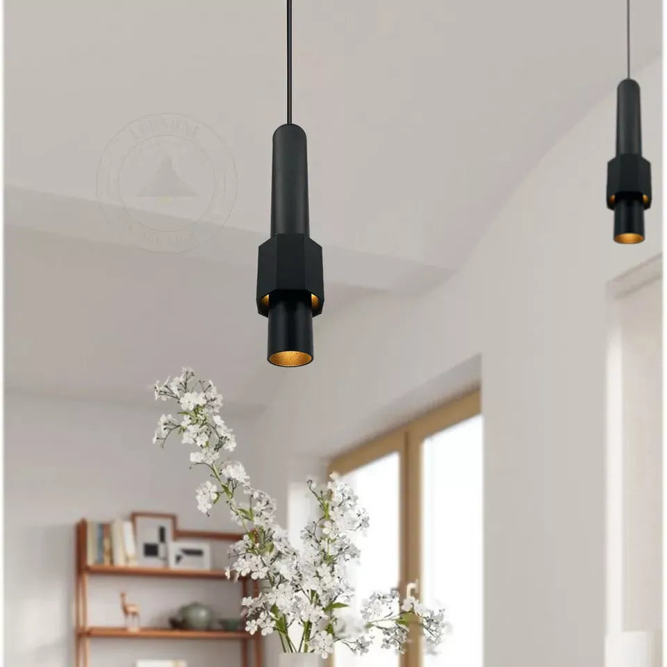 Modern LED pendant light casting focused light on a countertop


