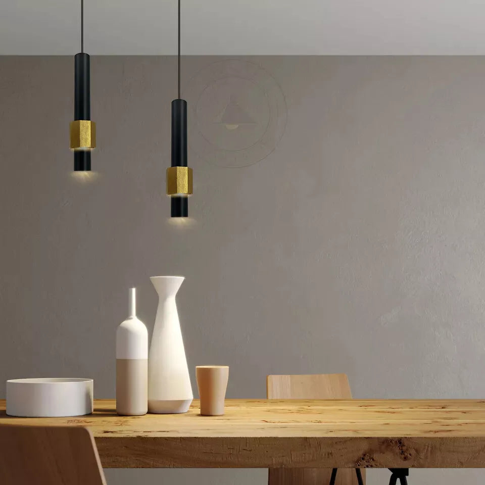 Sleek black and gold pendant light illuminating a dining area


