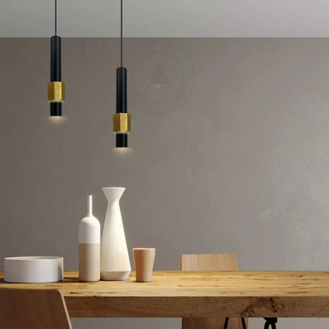 Sleek black and gold pendant light illuminating a dining area


