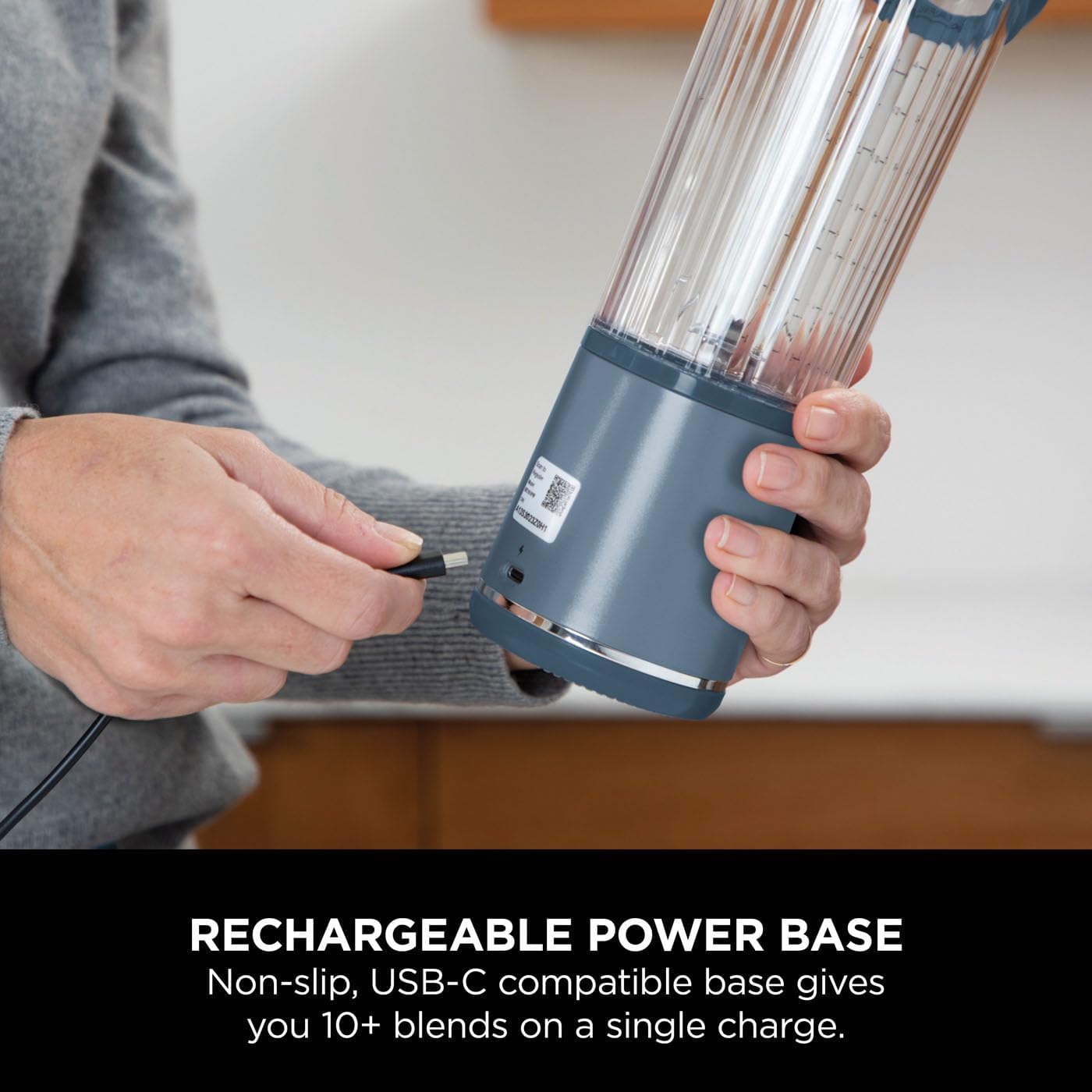 Person holding a blender with a rechargeable power base, showing USB-C compatibility.