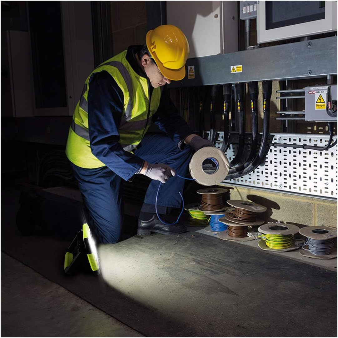 Person in safety gear working with spools of wire in a warehouse setting