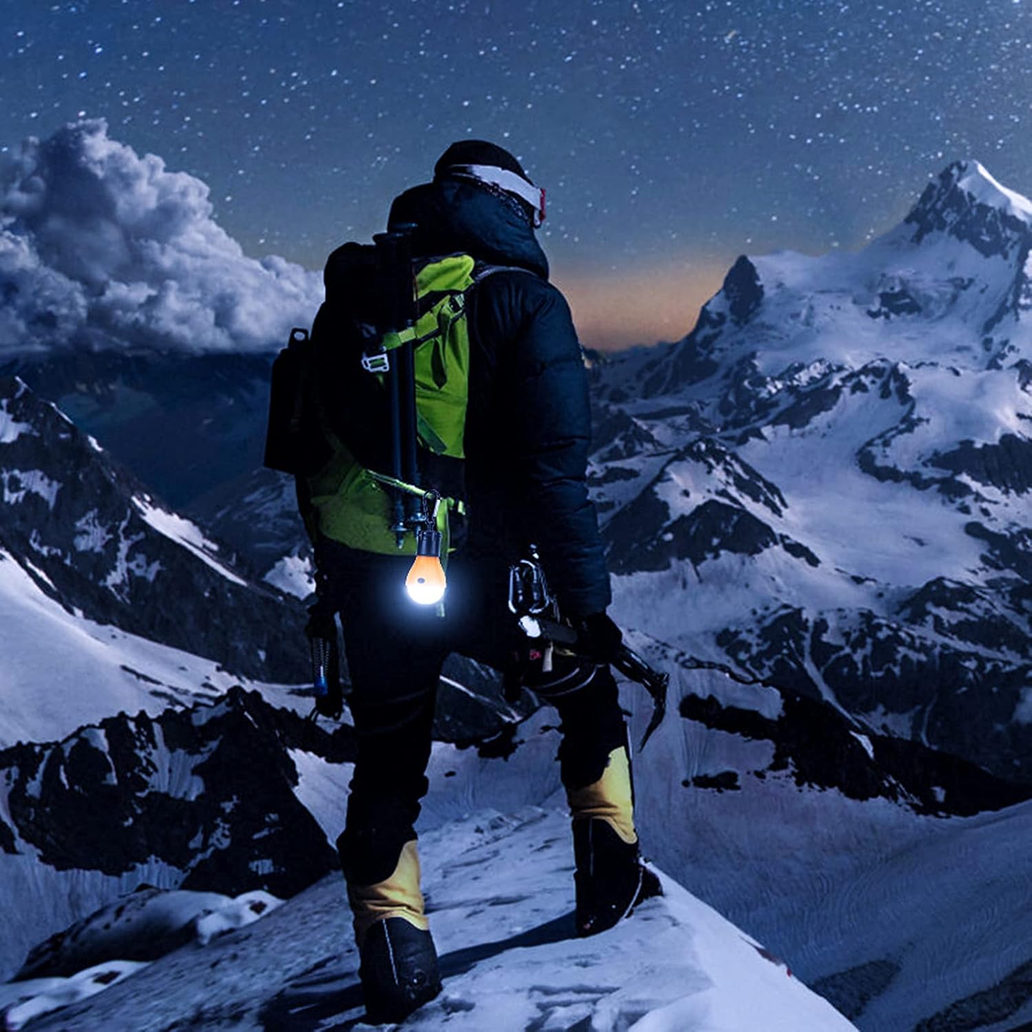 Person on a snowy mountain at night with a headlamp