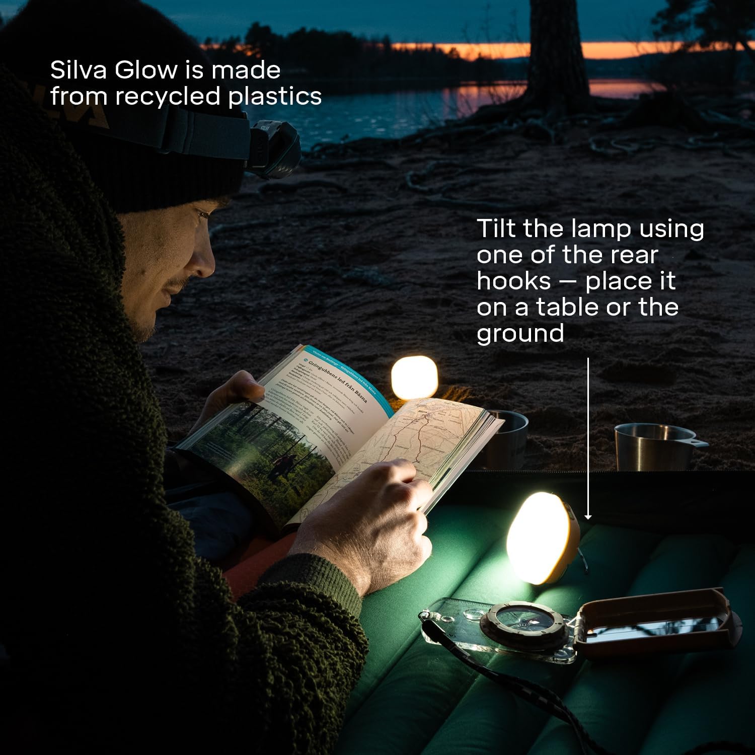 Person reading a book with Silva Glow lamp on a beach at night